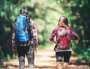 Rear of the couple hiking. Couple adventure travel.